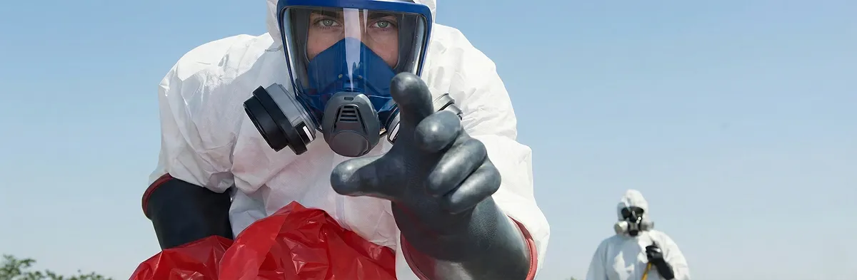sewage clean up technician wearing protective gear handling biohazard materials in Boulder, CO