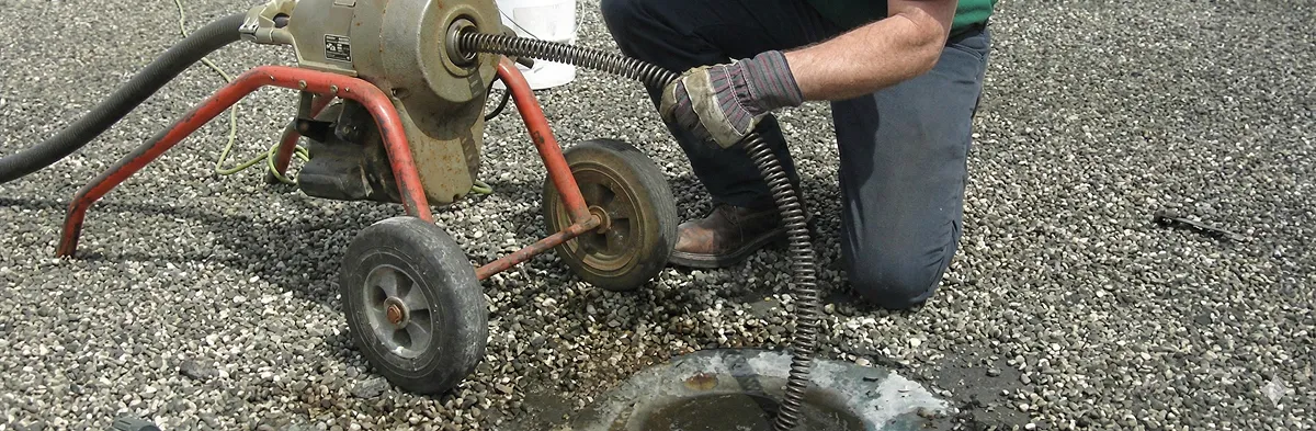sewer rodding technician actively removing blockages from a sewer line in Boulder, CO